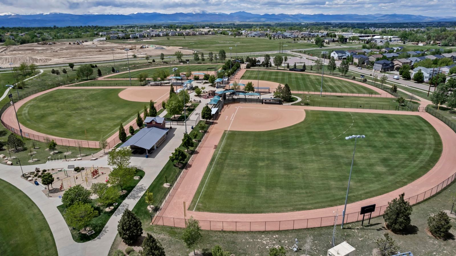 Ballfields with Front Range views in Colliers Hill — the next phase already grading in the distance