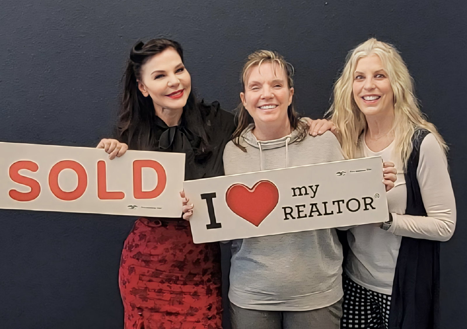 Christine Gwinnup with clients celebrating a sold Northern Colorado home
