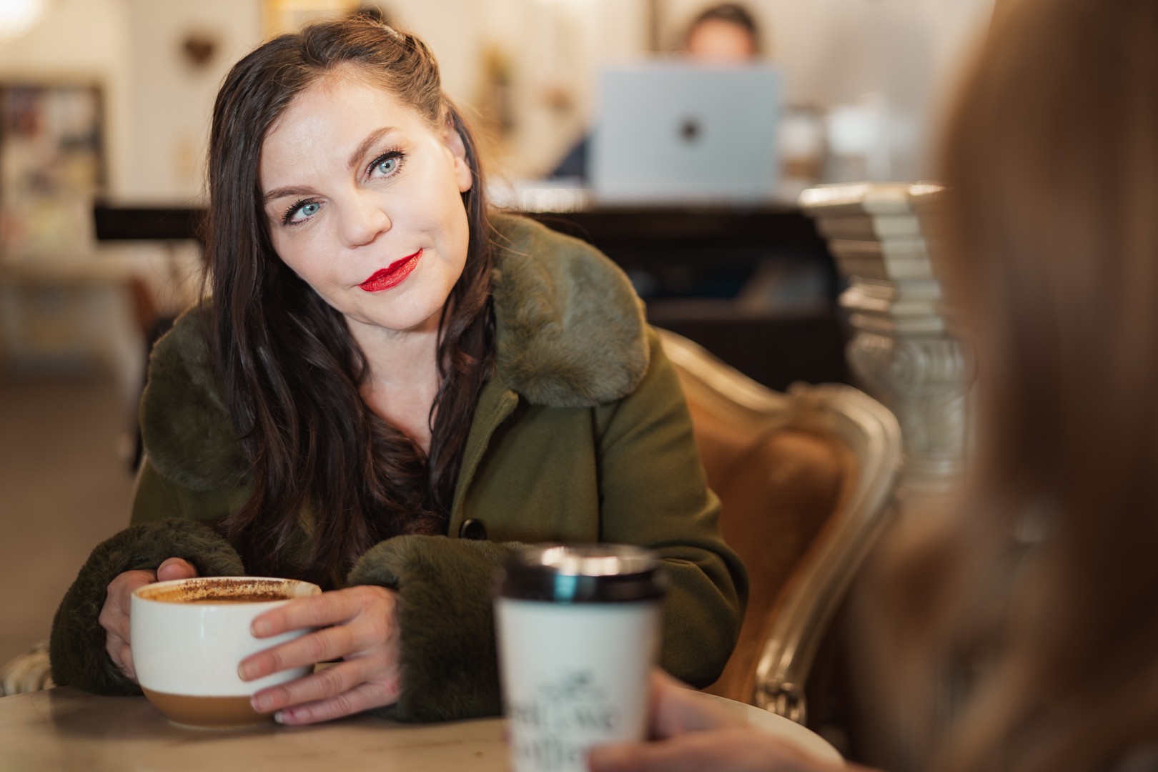 Christine Gwinnup over coffee at Feel Love Coffee in downtown Loveland, Colorado